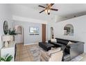 Bright living room featuring tile flooring, ceiling fan, modern furnishings, and arched doorways at 12817 Parkbury Dr, Orlando, FL 32828