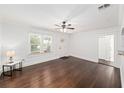 Bright living room with hardwood floors, large windows, and a ceiling fan at 1333 W Yale St, Orlando, FL 32804