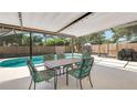 Outdoor dining area under a screened enclosure, overlooking the private pool at 1510 Jaguar Cir, Apopka, FL 32712