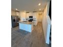 Modern kitchen featuring white cabinets, stainless steel appliances, and a granite island at 16464 Happy Eagle Dr, Clermont, FL 34714
