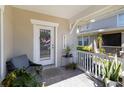 Welcoming front porch with chair, lush plants, and a 'Welcome' sign on the door at 2016 Cypress Bay Blvd, Kissimmee, FL 34743