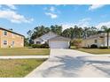 Inviting single-Gathering home with a two-car garage, neat landscaping, and a long driveway at 20335 Macon Pkwy, Orlando, FL 32833