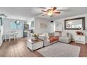 Bright living room featuring stylish furnishings, a ceiling fan, and modern decor at 2329 Oak Park Way # 204, Orlando, FL 32822