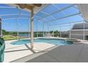 Screened-in pool and spa overlooking the lake and golf course at 2780 Highland View Cir, Clermont, FL 34711