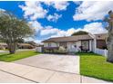 Charming single-story home with a well-maintained lawn and a quaint front garden at 3103 Yorych Ln, Orlando, FL 32822