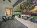 Inviting outdoor patio with comfortable seating, a fire pit, and a well-manicured lawn at 3420 Gerber Daisy Ln, Oviedo, FL 32766