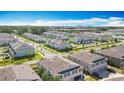 An aerial view showcasing the beautiful townhouse community, and lush landscaping with the city skyline in the background at 3449 Seneca Club Loop # B, Orlando, FL 32808