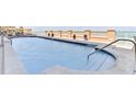 Inviting condo pool with clear blue water, decorative planters, and ocean view at 4071 S Atlantic Ave # 803, New Smyrna Beach, FL 32169