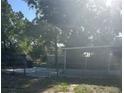 View of the fenced backyard with partial privacy and a covered, screened in patio at 435 N Observatory Dr, Orlando, FL 32835