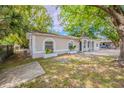 Charming single-story home with a spacious front yard and inviting curb appeal enhanced by mature trees at 4748 Amoy Ct, Orlando, FL 32811