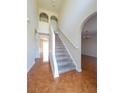 Bright foyer featuring tile flooring, staircase, and arched doorways at 502 Eagle Ct, Kissimmee, FL 34759
