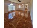 Open-concept living room showcasing decorative tile floors and arched windows at 502 Eagle Ct, Kissimmee, FL 34759