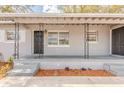 Inviting front porch with decorative iron supports, painted brick, and a cozy entrance at 5500 Riviera Dr, Orlando, FL 32808