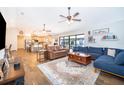 Spacious living room with modern furnishings, decorative shelving, and sliding glass doors that lead to an outdoor area at 659 N Endeavour Dr, Winter Springs, FL 32708