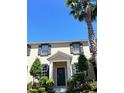 Beautiful two-story townhome showcasing classic architectural details, landscaping and sunny blue sky at 7675 Fordson Ln, Windermere, FL 34786