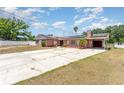 Charming brick home featuring a long driveway and well-kept lawn at 770 Manor Dr, Bartow, FL 33830