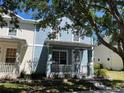 Charming blue two-story home with a cozy porch and well-maintained landscaping at 6327 Southbridge St, Windermere, FL 34786