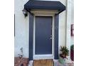 Exterior shot of the front door with a small canopy and visible lighting at 2141 Lake Margaret Dr # 11, Orlando, FL 32806