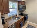 Efficient kitchen layout featuring stainless steel appliances and ample counter space at 2141 Lake Margaret Dr # 11, Orlando, FL 32806