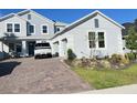 Charming two-story home with a well-maintained front yard and brick paver driveway at 2926 Crest Wave Dr, Clermont, FL 34711