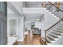Elegant foyer with hardwood floors, staircase with iron spindles, and a view of the living room at 2926 Crest Wave Dr, Clermont, FL 34711