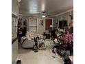 Bright living room with tile floor, ceiling fan, and ample natural light at 312 N Forest Ave, Orlando, FL 32803
