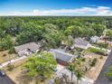 Expansive aerial view of a property with lush green surroundings and a well-maintained neighborhood at 1104 E University Ave, Deland, FL 32724