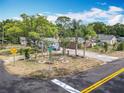 Charming home featuring mature trees, a circular driveway, and a well-maintained front yard at 1104 E University Ave, Deland, FL 32724