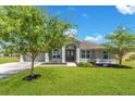 Charming single-story home with a well-manicured lawn, mature trees and a double-door entry, offers a warm and inviting curb appeal at 11630 Flynn Ct, Winter Garden, FL 34787