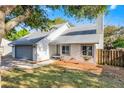 Charming one-story home with a gray roof, a gray garage door, and mature trees at 1220 Rolling Ln, Casselberry, FL 32707