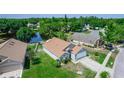 Beautiful aerial view of the home with its well-maintained lawn and serene water views at 13624 Springtide Ct, Orlando, FL 32826
