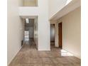 Hallway with high ceilings, tiled floors, and an abundance of natural light streaming in from multiple windows at 212 Hound Run Pl, Casselberry, FL 32707