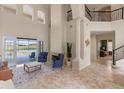 Open-concept living room showcasing a fireplace, high ceilings, tile floors, and access to the outdoor pool and patio at 2771 Willingam Dr, Davenport, FL 33837