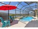A sparkling pool with elegant water features, and lounge chairs surrounded by a screened-in lanai at 2771 Willingam Dr, Davenport, FL 33837
