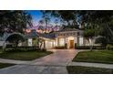 Beautiful one-story home with lush landscaping, and a large brick driveway and two-car garage at 3400 Oakmont Ter, Longwood, FL 32779