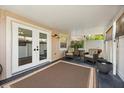 Relaxing covered patio with a neutral rug, comfortable seating, and sliding door access to the home at 5000 Ashford Falls Ln, Oviedo, FL 32765