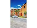 Lovely condo building featuring well-manicured greenery and ample parking at 5471 Vineland Rd # 7109, Orlando, FL 32811