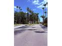 Scenic entry drive showcases meticulous landscaping leading to property entrance at 5471 Vineland Rd # 7109, Orlando, FL 32811