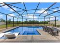Stunning screened-in pool area featuring a sparkling blue pool, spa, and comfortable outdoor seating at 5981 Sierra Crown St, Mount Dora, FL 32757