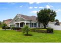 Beautifully landscaped home showcasing a manicured lawn, trimmed hedges, and a welcoming front porch at 690 Cascading Creek Ln, Winter Garden, FL 34787