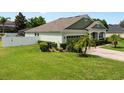 Inviting single-story home with a green lawn, beautiful landscaping, and fenced in yard at 690 Cascading Creek Ln, Winter Garden, FL 34787