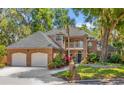 Charming two-story brick home with a three-car garage and well-manicured landscaping at 950 Deerwood Loop, Longwood, FL 32779