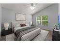 Light-filled bedroom featuring a large window, ceiling fan, and plush carpeting, creating a cozy retreat at 1111 Brielle Ct, Oviedo, FL 32765