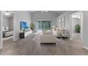 Bright living room boasts tile floors, sliding glass doors, and neutral décor for a modern, airy feel at 1111 Brielle Ct, Oviedo, FL 32765