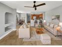 Living and dining area with tile flooring, ceiling fan, and open bar to the kitchen at 13839 Fairway Island Dr # 1128, Orlando, FL 32837