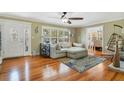 Bright living room with hardwood floors, a decorative fireplace, and a large window at 1405 Pioneer Trl, New Smyrna Beach, FL 32168