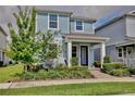Charming two-story home with a lovely brick path to the entry and professionally landscaped front yard at 14374 Lanikai Beach Dr, Orlando, FL 32827