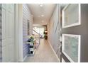 Inviting home entryway showcasing decorative wallpaper, tile flooring, and a glimpse into the open-concept living space at 1624 Tropical Palms Cir, Kissimmee, FL 34747
