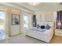 Luxurious main bedroom with tray ceilings, ambient lighting, plush carpet, and elegant decor for a relaxing retreat at 1624 Tropical Palms Cir, Kissimmee, FL 34747