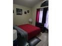Bedroom with a red bedspread and dark wood dresser at 1639 Nestlewood Trl, Orlando, FL 32837